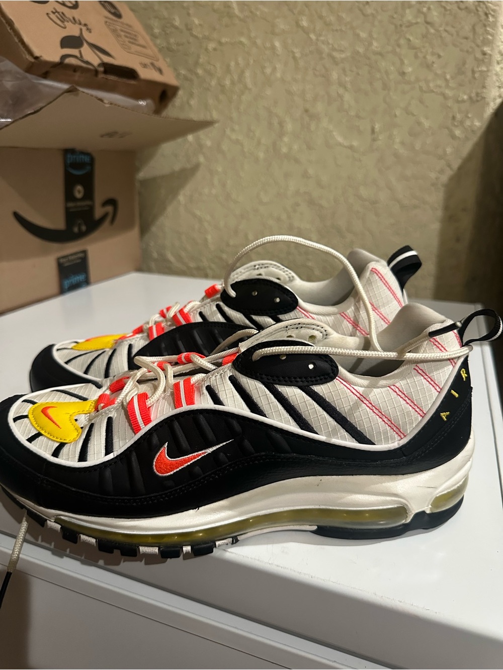 Nike Kids Sneakers in White, Black, Yellow & Red-Orange Accents